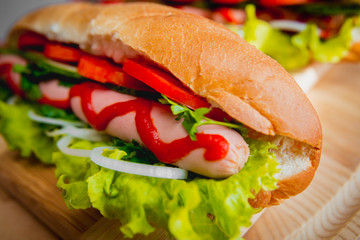 Large hot dog with vegetables