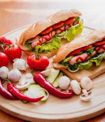 Large hot dog with vegetables