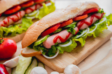 Large hot dog with vegetables