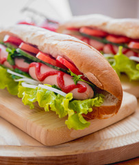 Large hot dog with vegetables