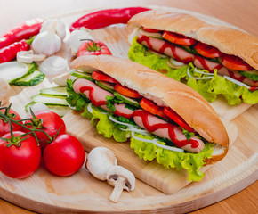 Large hot dog with vegetables