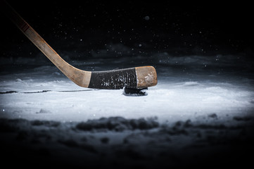 Hockey stick and puck on ice
