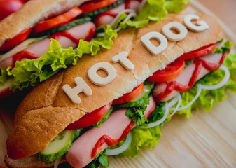 Large hot dog with vegetables
