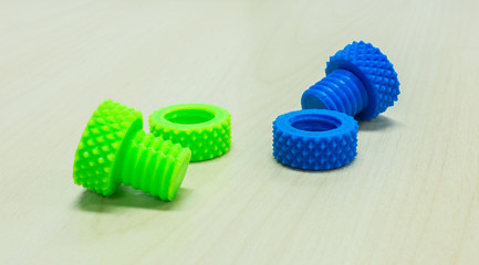 Colorful Creative Plastic Screw Nuts Bolts and Rings made by 3D Printer on Wooden Table