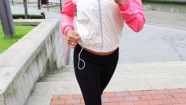 Woman running on stairs in the street.