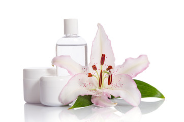 cosmetic set for skin care on a white background with lily flowe