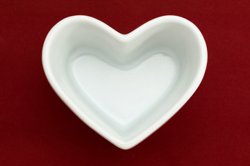 heart-shaped dish on the red background for valentine's day