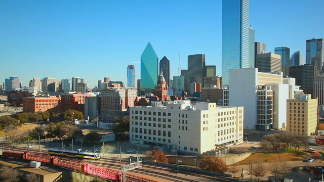 Day footage of Dallas skyline, road, and trainyard