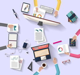 Flat design - top view of coworkers team working together around a desk with a desktop and laptop and tablet, the desk contain a set of objects - this presents creative team, bright ideas, corporation