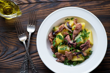 Smoked octopus and potato salad, view from above, close-up