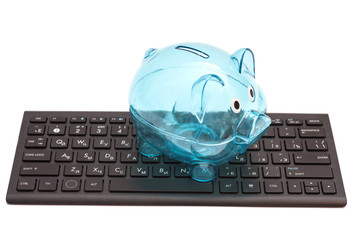 Glass piggy bank on black keyboard