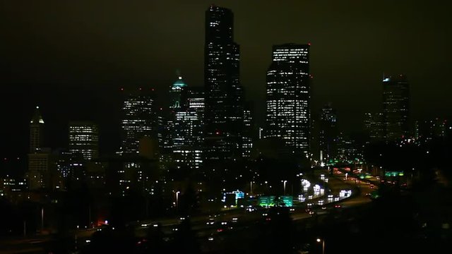 Static view of Seattle at night as traffic drives by.