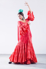 Pretty young flamenco dancer in beautiful dress.