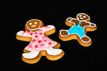 Gingerbread man, mother and son on black velvet