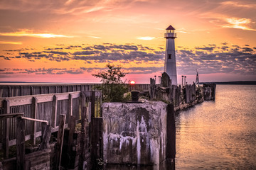 Lighthouse Sunrise. The Wawatam Lighthouse in St. Ignace, Michigan as sun rises over Lake Huron. - obrazy, fototapety, plakaty