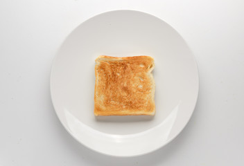Toasted slice of bread on white plate