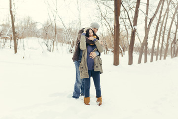 Fototapeta na wymiar Cheerful young couple walking in a winter day