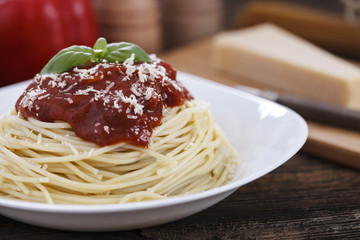 Warm, delicious spaghetti with sauce and basil.