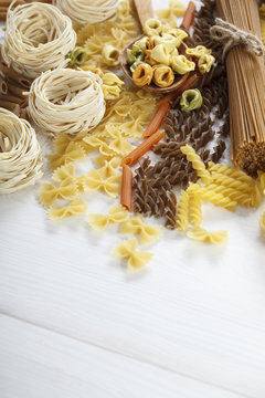 A set of raw pasta on a wooden table
