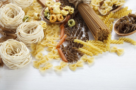 A set of raw pasta on a wooden table