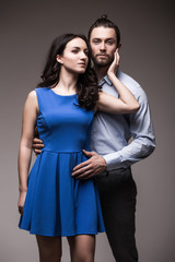 young happy smiling attractive couple, isolated on grey background