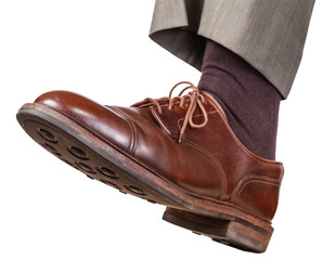male left foot in brown shoe takes a step