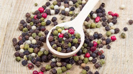 Color pepper on a wooden background.