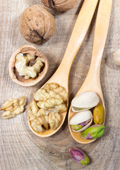 Closeup of a walnut and pistachios.