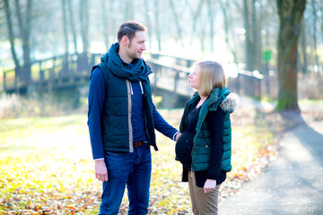 pregnant woman with her husband in the park