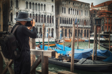photographer records a snapshot on the background of Venetian ho
