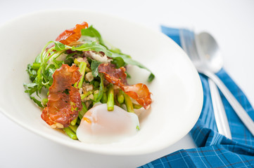 Vegetables salad with balsamic vinegar dressing, onsen tamago (Japanese style scald egg) and smoked striploin ham 1.5 millimeters thickness in ceramic bowl, a modern cusine concept food