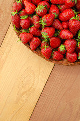 Strawberry in basket on colorful wooden table