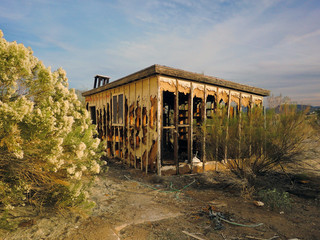 Abandoned shack in the middle of the Arizona desert with blue sky