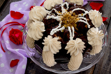 Cake with whipped cream, nuts and chocolate