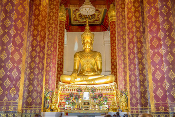 Fototapeta premium Golden color The crowned Buddha in the ubosot at Wat Naphrameru