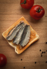 Canned sardines on toasted slice of bread
