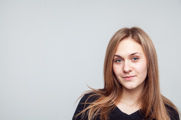 Fototapeta premium Attractive woman with black t-shirt isolated on a over white background