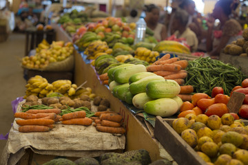 Many different vegetables on shelfs on an Asian market