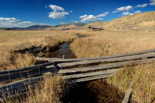 Idaho farm field with Log Cabin