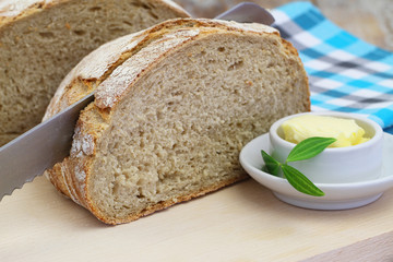 Brown bread on wooden board and butter
