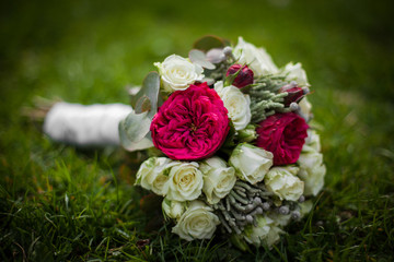 Wedding bouquet of freshly cut flowers, roses and peonies on gra