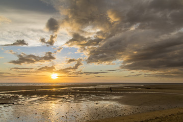Fototapeta na wymiar Yellow african sunset on a plain beach