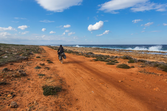 alone rider on a sea coast