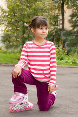 Fototapeta premium Little girl portrait summer outdoors on the rollers 