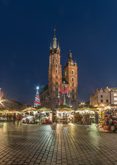 Fototapeta premium Krakow, Poland, Main Market square and Cloth Hall in the winter season, during Christmas fairs decorated with Christmas tree.