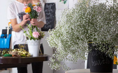 Florist making bright orange and pink bouquet