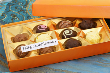 Feliz cumpleanos (happy birthday in Spanish) card with box of assorted chocolates
