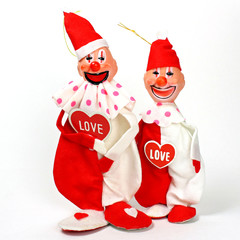 A pair of vintage felt clown dolls with hearts. 