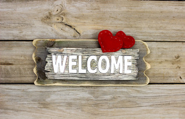 Rustic welcome sign with red hearts