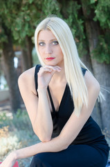 Obraz premium Portrait of a pretty blonde woman, photo taken outside
